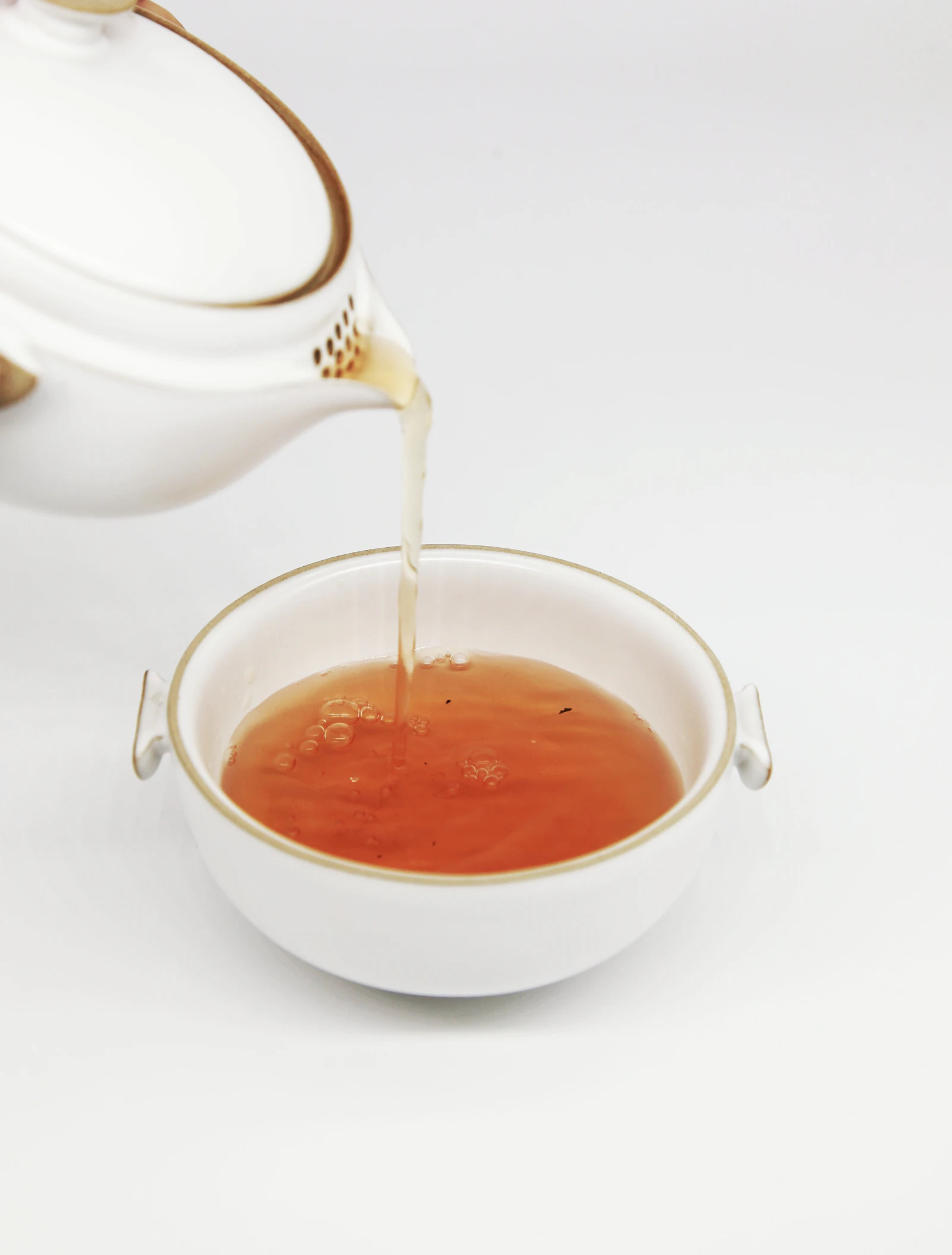 Gongfu tea brewing with hot water being poured into a gaiwan